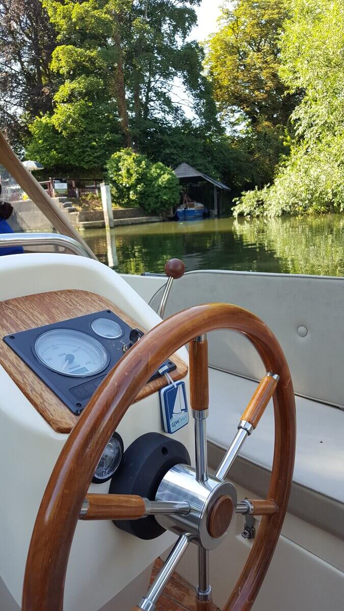 Eliza Grace helm The helm of 6-seater boat for hire in Henley-on-Thames